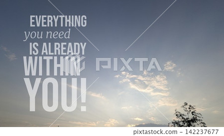 A vertical composition shows soft blue sky filled with bright dusk clouds glowing above tree silhouetted leaves. Overlaid motivational wisdom typography text states "EVERYTHING you need IS ALREADY A vertical composition shows soft blue sky filled with bright dusk clouds glowing above tree silhouetted leaves. Overlaid motivational wisdom typography text states "EVERYTHING you need IS ALREADY 142237677