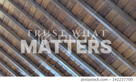 Inspirational quote text overlay on a brown wooden ceiling structure background, written in clean typography. The visual features the motivational quote, Trust what matters. This image emphasizes Inspirational quote text overlay on a brown wooden ceiling structure background, written in clean typography. The visual features the motivational quote, Trust what matters. This image emphasizes 142237700
