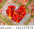 A large red heart drawn on the ground 142237878