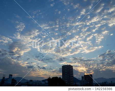 Clouds and cityscapes spread across the morning sky. Clouds and cityscapes spread across the morning sky. 142238366