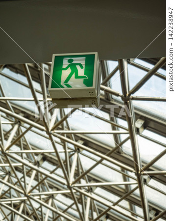 Emergency exit signs and steel frame structure reflected in a mirror Emergency exit signs and steel frame structure reflected in a mirror 142238947