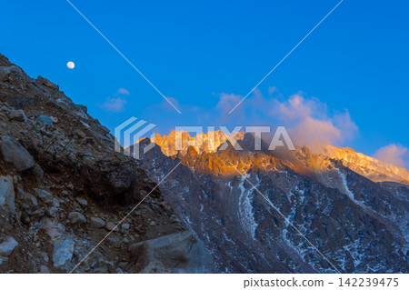 Dramatic Mountain Landscape at Sunrise with Full Moon Dramatic Mountain Landscape at Sunrise with Full Moon 142239475