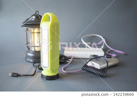 Emergency preparedness lighting equipment. Portable flashlight, torch, power banks, cables and external batteries: portable solutions for power and lighting in emergency situations. Emergency preparedness lighting equipment. Portable flashlight, torch, power banks, cables and external batteries: portable solutions for power and lighting in emergency situations. 142239660