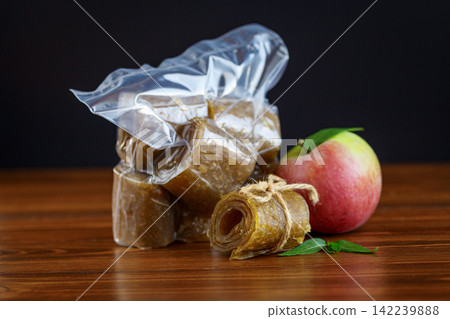 Homemade apple pastila packed for storage on wooden background 142239888