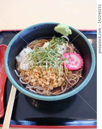 A bowl of soba noodles on a red tray; a Japanese lunch viewed from directly above. A bowl of soba noodles on a red tray; a Japanese lunch viewed from directly above. 142240231
