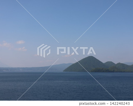 A view of Nakajima Island floating in Lake Toya; a clear summer view of the lake. 142240243