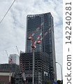 A view of a high-rise building under construction. 142240281