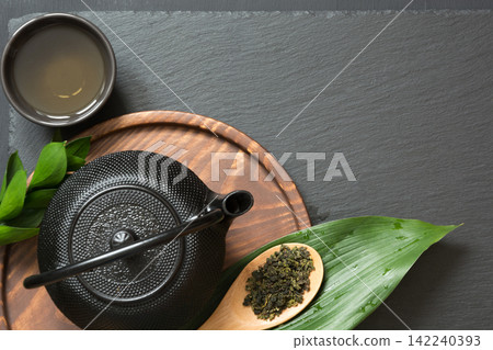 Green tea on black slate. Top view with copy space. Green tea on black slate. Top view with copy space. 142240393