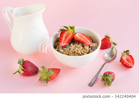 Healthy breakfast of granola, strawberry and milk on pink. Summer. Healthy breakfast of granola, strawberry and milk on pink. Summer. 142240404