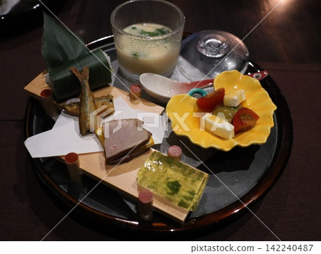 A colorful Japanese dish: an appetizer served on a black tray as part of a kaiseki meal. A colorful Japanese dish: an appetizer served on a black tray as part of a kaiseki meal. 142240487