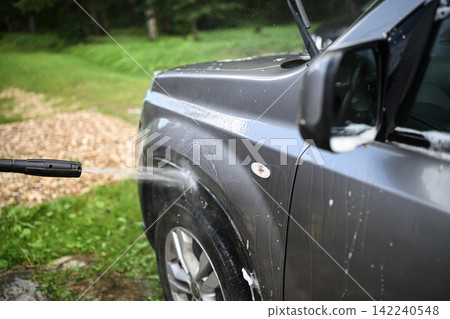 Pressure washing car body with powerful high pressure water jet Pressure washing car body with powerful high pressure water jet 142240548