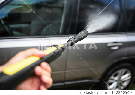 Using pressure washer to clean car with high pressure water jet Using pressure washer to clean car with high pressure water jet 142240549