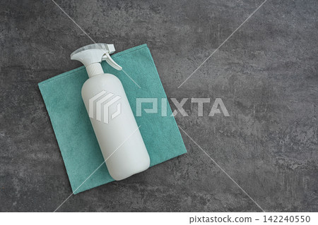 Cleaning spray bottle and microfiber cloth flat lay with copy space Cleaning spray bottle and microfiber cloth flat lay with copy space 142240550