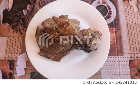 Grilled bone in beef steak on a white plate 142241030