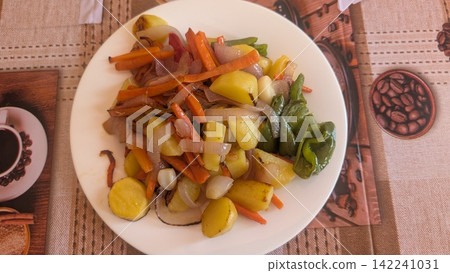 Stir fried potatoes and vegetables on a white plate Stir fried potatoes and vegetables on a white plate 142241031