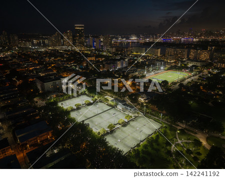 Miami, Florida, USA - June 10, 2025: Sport activity in Flamingo park. Sport activity. Aerial basketball and football field in park. Night Miami beach cityscape. Tennis field aerial view at night Miami, Florida, USA - June 10, 2025: Sport activity in Flamingo park. Sport activity. Aerial basketball and football field in park. Night Miami beach cityscape. Tennis field aerial view at night 142241192