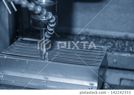 Rough cutting process on steel mold parts using indexable milling tool on CNC machine in light blue tone Rough cutting process on steel mold parts using indexable milling tool on CNC machine in light blue tone 142242353