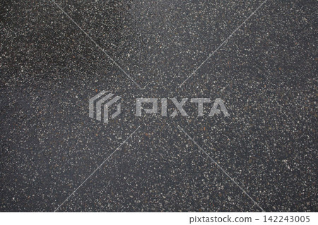 Wet asphalt after the rain close up. Minimalistic background, texture of the road after raining, weather changes. Wet asphalt after the rain close up. Minimalistic background, texture of the road after raining, weather changes. 142243005