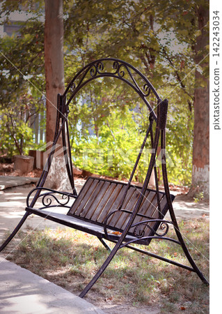 wooden chaise lounge in the park wooden chaise lounge in the park 142243034