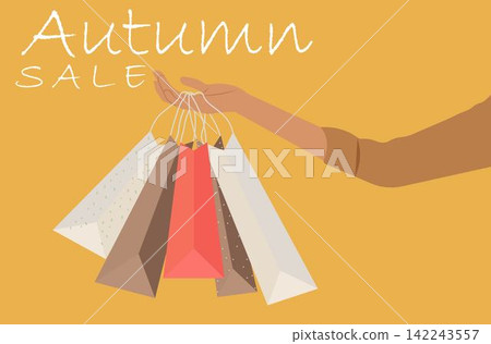 A woman's hand holding shopping bags Autumn sale A woman's hand holding shopping bags Autumn sale 142243557