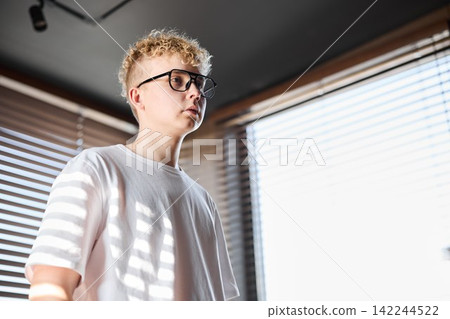 Casual teen in sunlight. Male teen with glasses in natural light Casual teen in sunlight. Male teen with glasses in natural light 142244522