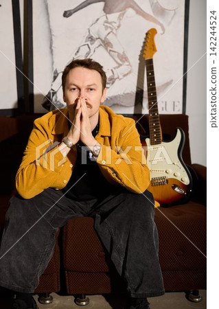 Creative musician strategizes song lineup amidst studio environment 142244524
