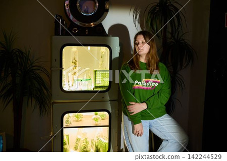Startup founder exhibiting sustainable indoor plant development setup Startup founder exhibiting sustainable indoor plant development setup 142244529
