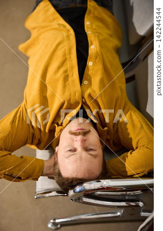 Aerial perspective showing man relaxing on station furniture 142244544
