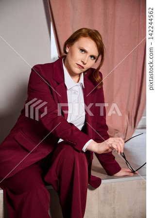 Elegant female entrepreneur relaxing during busy workday Elegant female entrepreneur relaxing during busy workday 142244562