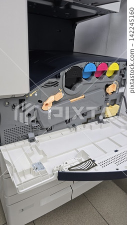Open laser printer tray showing internal toner cartridges with black, cyan, magenta, and yellow color ink. Open laser printer tray showing internal toner cartridges with black, cyan, magenta, and yellow color ink. 142245160