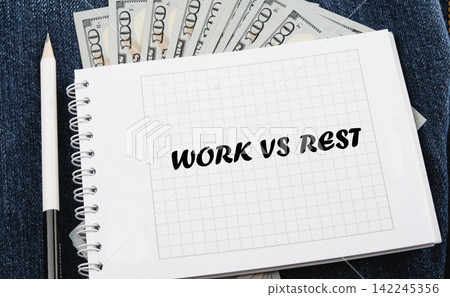 Work vs Rest text on a squared notepad placed over US dollar bills and blue jeans fabric with a pencil Work vs Rest text on a squared notepad placed over US dollar bills and blue jeans fabric with a pencil 142245356