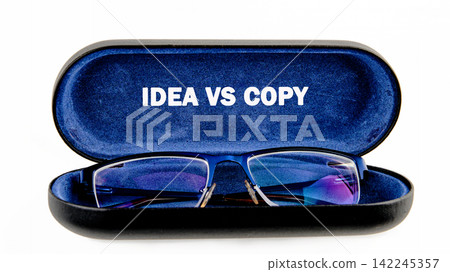 Idea vs Copy text written inside an open blue glasses case with eyeglasses on a white background Idea vs Copy text written inside an open blue glasses case with eyeglasses on a white background 142245357