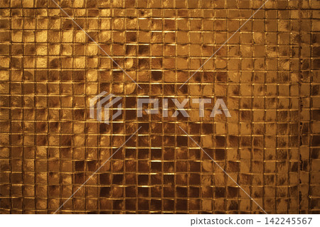 Textured golden mosaic wall with small square tiles reflecting light, creating a shimmering effect in a warm and luxurious atmosphere Textured golden mosaic wall with small square tiles reflecting light, creating a shimmering effect in a warm and luxurious atmosphere 142245567