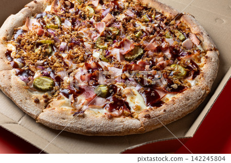 Closeup of Barbecue Bacon Pizza with Pickles and Cheese 142245804
