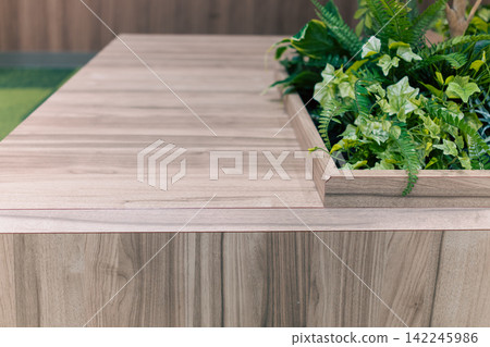 A space with a wooden counter and abundant houseplants. A space with a wooden counter and abundant houseplants. 142245986