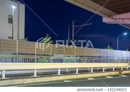 Elevated structures and guardrails along the roadside at night Elevated structures and guardrails along the roadside at night 142246021