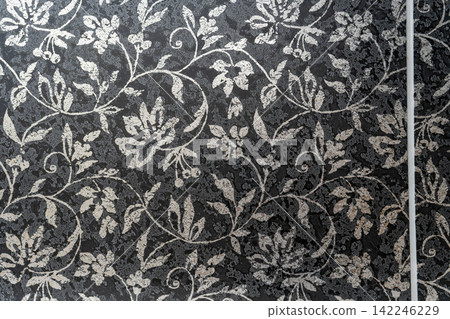 A chic black background with a white arabesque botanical floral texture. A chic black background with a white arabesque botanical floral texture. 142246229