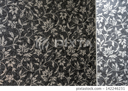 A chic black background with a white arabesque botanical floral texture. A chic black background with a white arabesque botanical floral texture. 142246231
