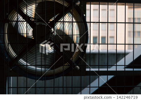 A machinery and equipment area lined with large industrial axial flow fans. A machinery and equipment area lined with large industrial axial flow fans. 142246719