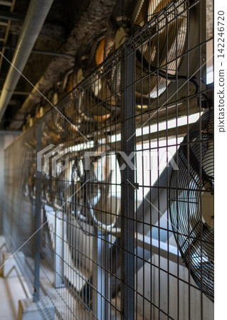 A machinery and equipment area lined with large industrial axial flow fans. A machinery and equipment area lined with large industrial axial flow fans. 142246720