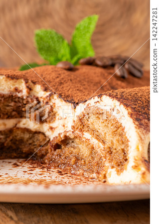 Delicious homemade tiramisu cake topped with cocoa Delicious homemade tiramisu cake topped with cocoa 142247281