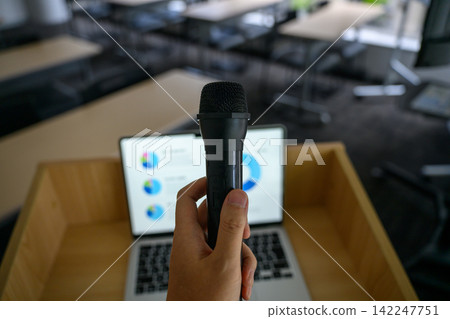 A microphone and laptop on the podium A microphone and laptop on the podium 142247751