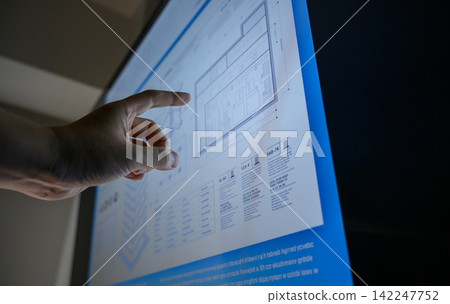 A hand tracing an architectural drawing with its finger. A hand tracing an architectural drawing with its finger. 142247752