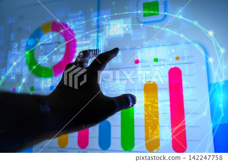 A businessman manipulating graphs with his fingers A businessman manipulating graphs with his fingers 142247758