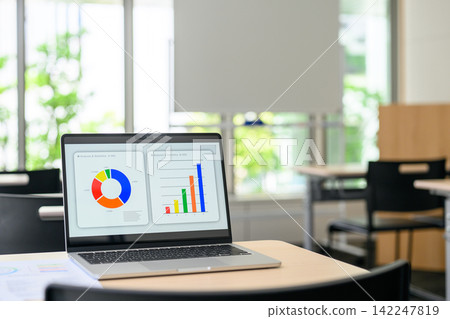 Laptop and graph on the desk Laptop and graph on the desk 142247819