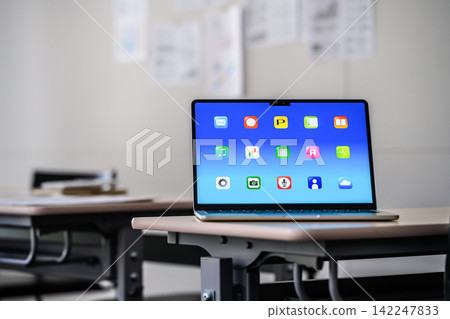 The app screen of a laptop placed on a classroom desk. The app screen of a laptop placed on a classroom desk. 142247833