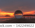 Artistic Beach Sunset Reflected in a Transparent Glass Ball 142249022