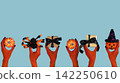 Hands holding Halloween gifts and pumpkins for seasonal celebration concept 142250610