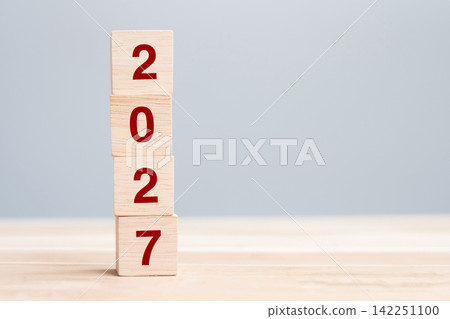 wooden cube block with 2027 text on table background. Resolution, plan, review, goal, start and New Year holiday concepts wooden cube block with 2027 text on table background. Resolution, plan, review, goal, start and New Year holiday concepts 142251100