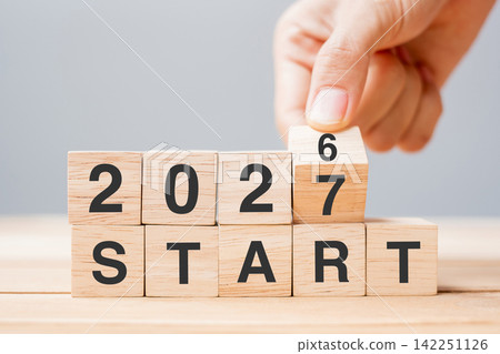 hand flipping block 2026 to 2027 START text on table. Resolution, strategy, goal, motivation, reboot, business and New Year holiday concepts hand flipping block 2026 to 2027 START text on table. Resolution, strategy, goal, motivation, reboot, business and New Year holiday concepts 142251126